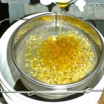 straining honey through a screen